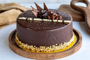 Chocolate birthday cake on a white background. Cake with croquant and cream filling. Bakery products. close up