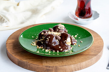 Profiterole on a white background. Profiterole filled with milk cream. Bakery products. close up