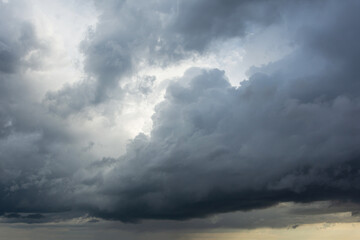Powerful cumulus clouds with a dark base, a harbinger of bad weather and heavy rains.