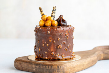 Chocolate cake on a white background. Cake with croquant and cream filling. Bakery products. close up