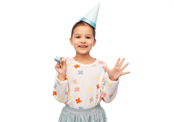 birthday, childhood and people concept - portrait of smiling little girl in party hat with blower...