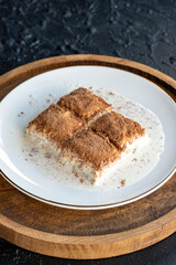 Cold baklava on a dark background. Baklava with pistachio milk. Traditional Turkish cuisine delicacies. The new trend is baklava. close-up. local name soguk baklava