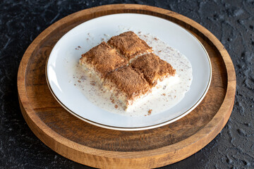 Cold baklava on a dark background. Baklava with pistachio milk. Traditional Turkish cuisine delicacies. The new trend is baklava. close-up. local name soguk baklava