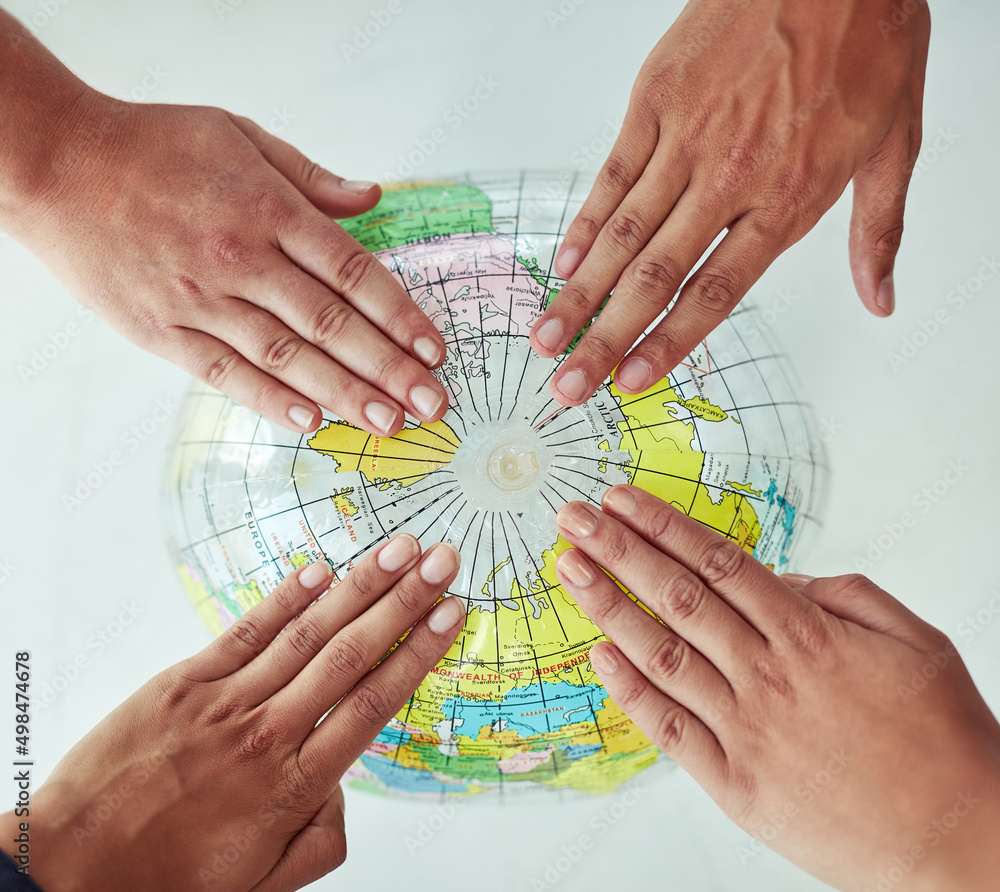 Poster Reach out to the world. High angle shot of a group of unrecognisable people with their hands on a world globe.