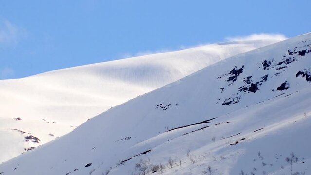clouds rolling over snow in the mountains time lapse close up.