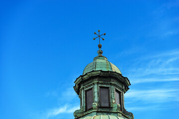 Close-up of the Treviso Cathedral (Duomo o Cattedrale di San Pietro Apostolo - Saint Peter the Apostle), VI-XIX century, Veneto, Italy, Europe. Dome with lantern and cross on blue sky with clouds.