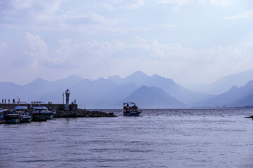 Kaleiçi bay in Antalya. Boats are sailing, turists are walking around