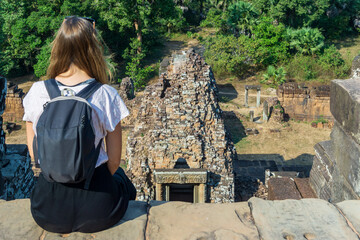 Young female tourist enjoying the views in Angkor Wat, Siem Reap, Cambodia.