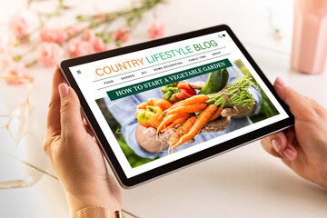 Country lifestyle blog -  website on tablet. Internet tips for rural living and gardening - made up...