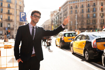 Businessman catching taxi in city.