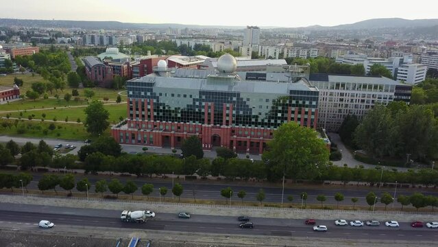 Cinematic 4K aerial drone orbit shot of L&aacute;gym&aacute;nyosi ELTE Campus Southern Block, University of Technology and Economics, Kopaszi-g&aacute;t by the Danube river in Budapest, Hungary