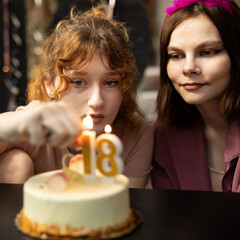 Happy friends birthday party with candle celebration cakes. Teens Grils celebrating birthday party.
