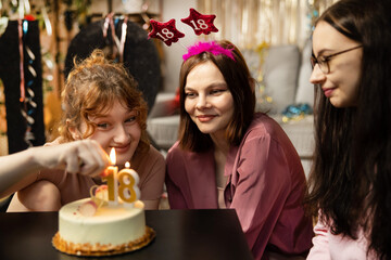 Friends presenting birthday cake to girl. Happy birthday to you