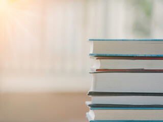 A simple composition of many books, stack or pile of books on wooden table, one of them open with copy space.