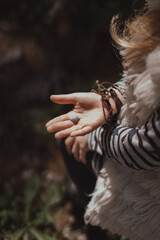Child's hand holding a wood snail shell. Happy childhood outdoor
