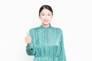 白背景の前で良いねのポーズをする主婦