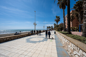promenade in the city of Malaga, Spain with people walking for exercise. 