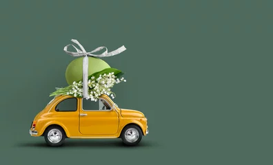 Poster Retro auto met een paasei bovenop met lelietje-van-dalenbos. Vrolijk Pasen achtergrond © Soho A studio