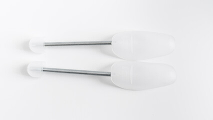 Flexible plastic spring mold holders for shoes on a white background. to preserve the shape of leather shoes and sneakers during natural drying and storage.