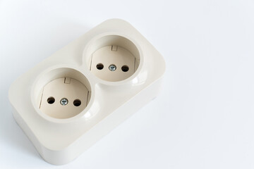 Double socket on a white background. two sockets, united by one monolithic case. The socket has two plug connectors, but is installed in one standard socket. electrical goods store.