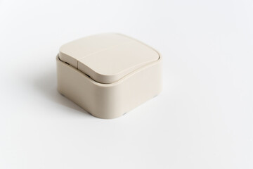Two-key light switch on a white background. mechanical device for switching the lighting circuit, has two control keys. shop of electronic devices for the home.
