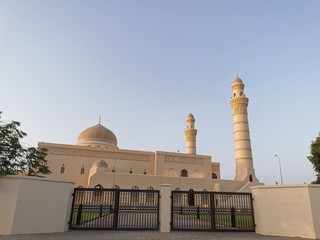 Fototapeta premium The Grand mosque of Manah city in Oman, Which is called Sultan Qaboos, Arabic text translation: words from the holy Quran, verse 10 of Surat Al Jumuah