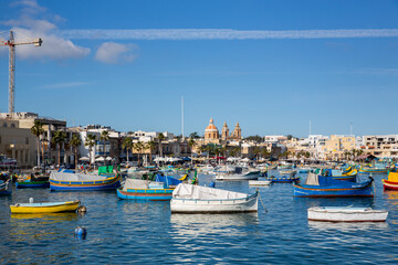 Fototapeta na wymiar Colourful boats in Marsaxlokk Port, Malta, Europe
