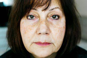 Close up portrait of a middle aged woman with focus on the nose - cinematic coloring.