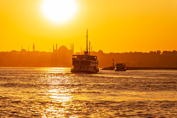 amazing sunset with blue sky and clouds. Ferries passing by Bosporus with sunset