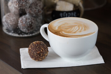 cup of coffee served with a cake ball