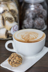 cup of coffee served with a cake ball