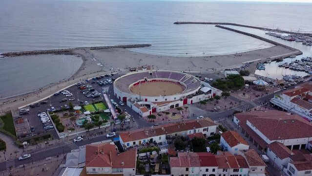 Cinematic 4K aerial drone footage of Arenas of Saintes Maries de la Mer in Saintes-Maries-de-la-Mer, Saint Marys of the Sea, capital of the Camargue in the south of France, by the Mediterranean Sea