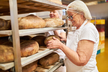 Female baker checking the quality of baked bread