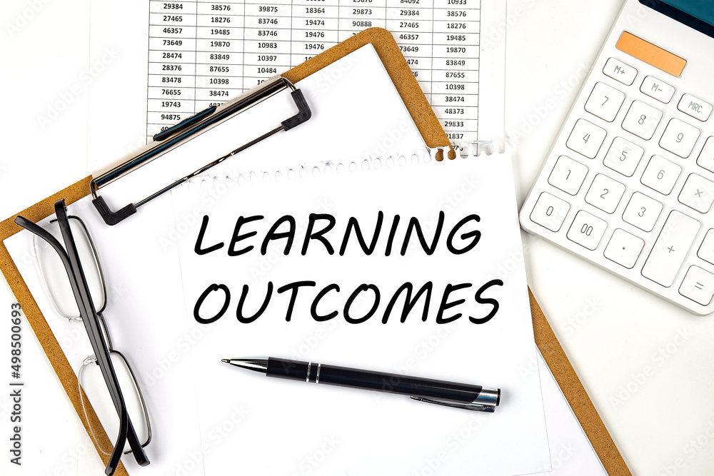 Poster text learning outcomes on the white paper on clipboard with chart and calculator