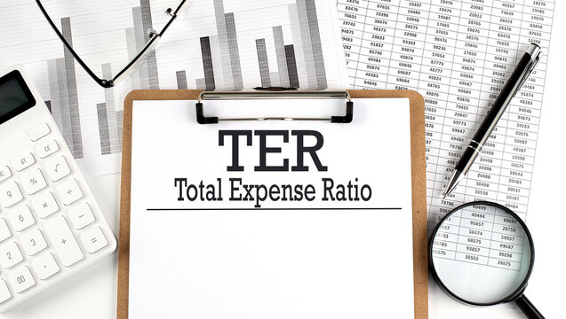 Paper with TER TOTAL EXPENSE RATIO table on charts, business concept