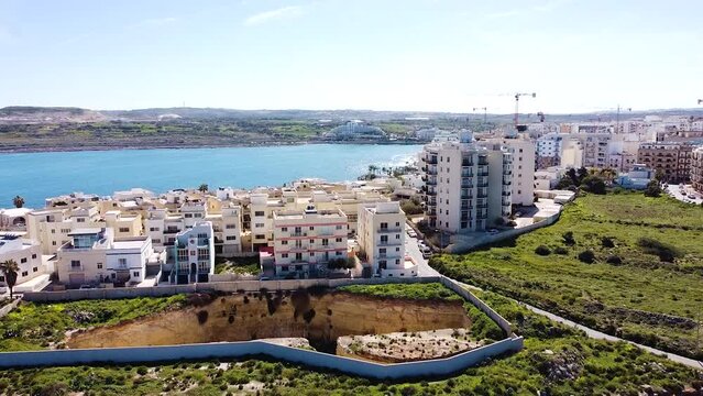 Massive building foundation ready for build. Malta island development. Aerial ascend view
