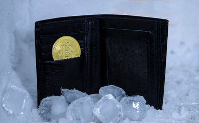  A representative crypto currency cold wallet image, which a real wallet is inside a fridge and ice cubes around and a bitcoin figurine inside the wallet
