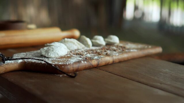 Russian fresh handmade dumplings lying on the wooden table on the cutting board