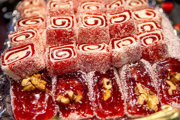 Oriental Sweets. Traditional Turkish Delight (Rahat Lokum) Close-up. Turkish Delight with walnuts and coconut shavings. Top view.