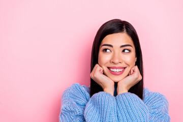 Portrait of attractive cheerful cute brown-haired girl thinking guess copy space isolated over pink pastel color background