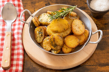 sarladaise potatoes in a dish with rosemary