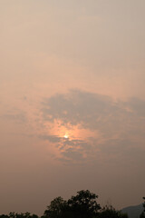 Vanilla sky with cloud and sunlight above trees before sunset, Natural background