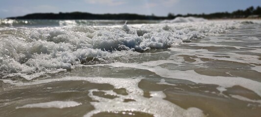 Wonderful beach on the blue ocean in the Dominican Republic. Beautiful tropical water view. White clean sand, curly waves. Concept photo can be used as wallpaper, background