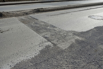 damaged and repaired asphalt road, damaged patched asphalt road,