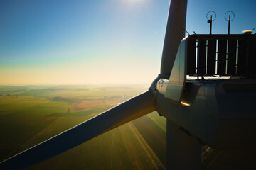 Aerial view of close up windmill turbine in countryside area, Wind power and renewable sustainable...