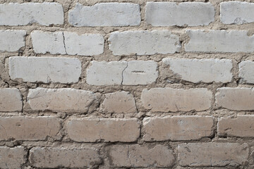wall of white sand-lime brick, uneven masonry