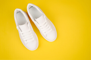 Stylish women's leather shoes with laces on a yellow background. Seasonal sales, promotions, discounts on casual shoes. Proper care for white skin.View from above.Copyspace