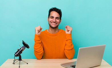 hispanic handsome man feeling shocked,laughing and celebrating success. influencer concept