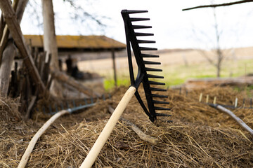 the rake lies on the hay with selective focus