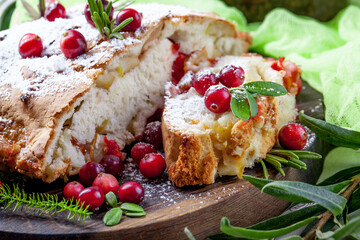 Delicious cranberry pie with fresh cranberries and herbs for Christmas on wooden plate - 498512419